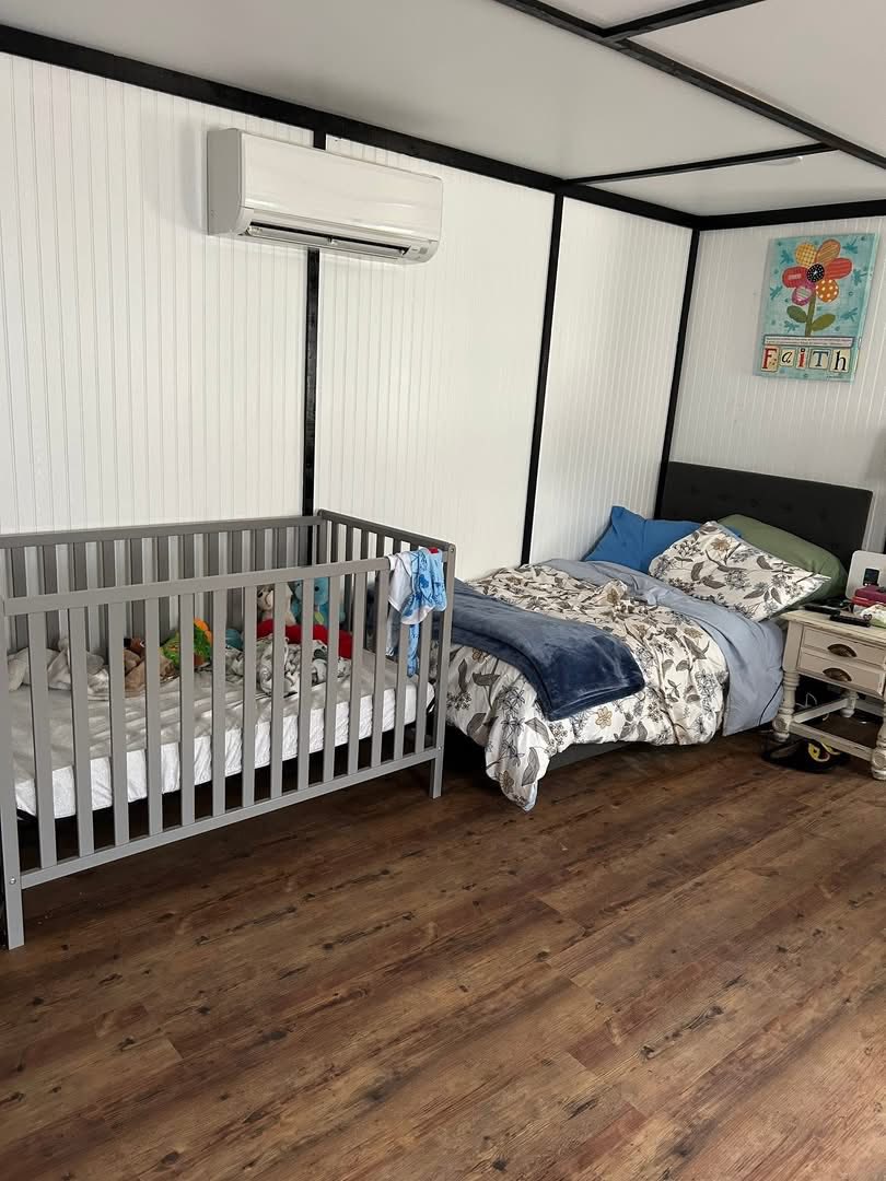 Tiny house bedroom with bed and crib side by side